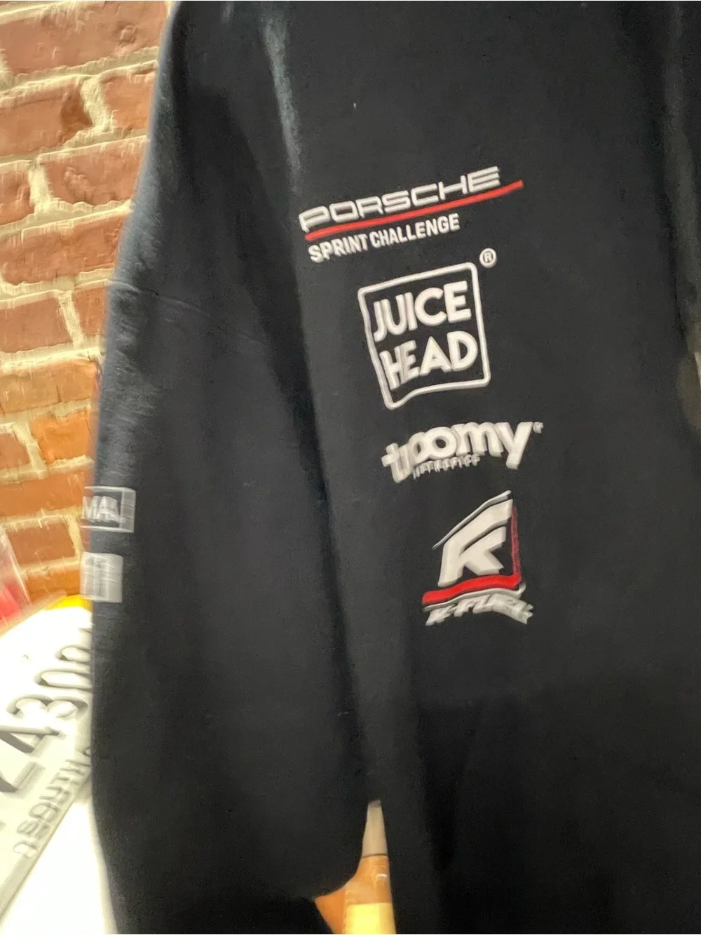 motorsport-style pullover hoodie featuring various sponsor and brand logos